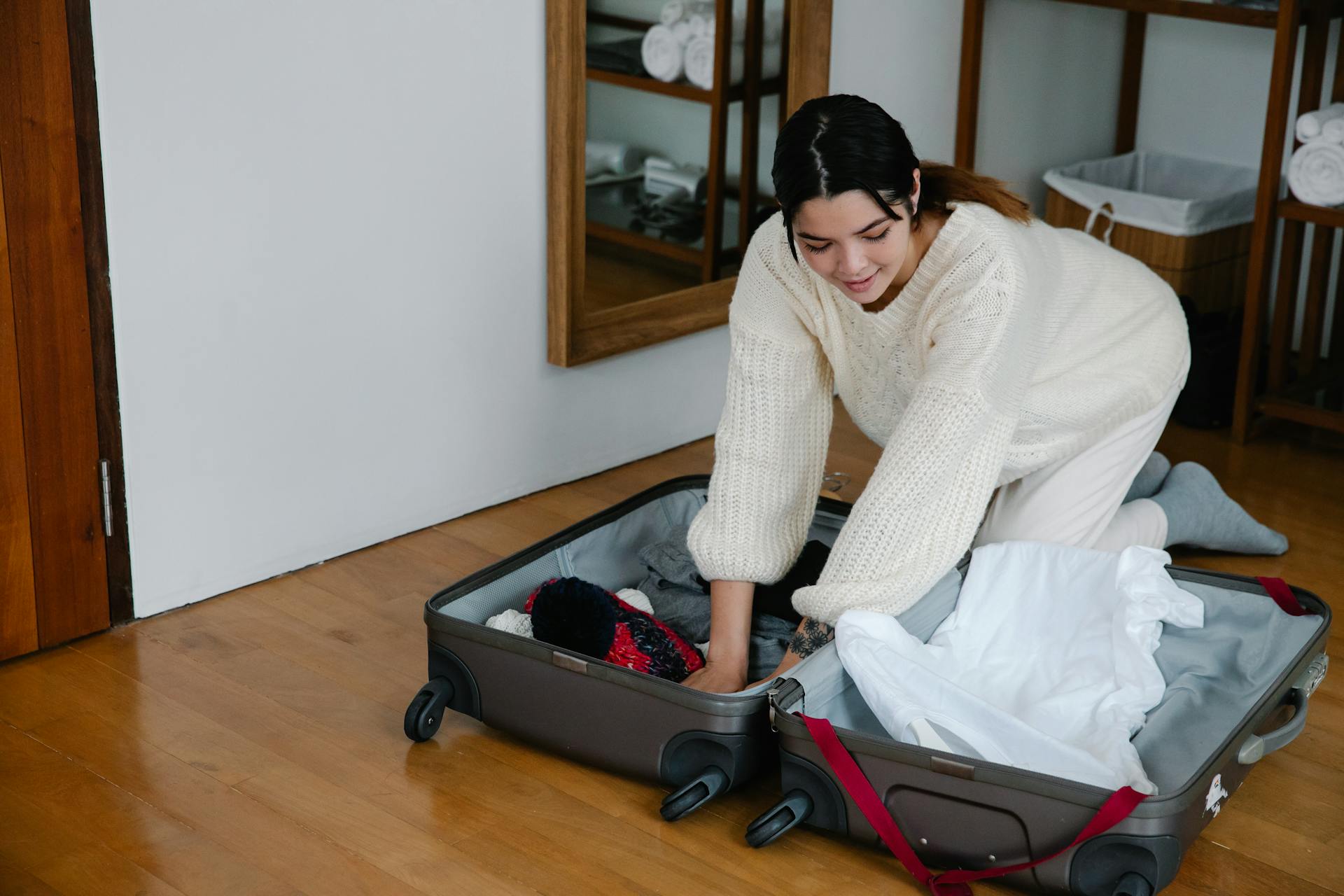 Woman packing suitcase to leave to Colombia and obtain second residency.